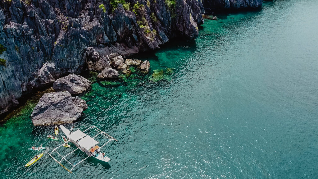 Drone photo of traditional boat in Cadlao Lagoon, El Nido, Philippines